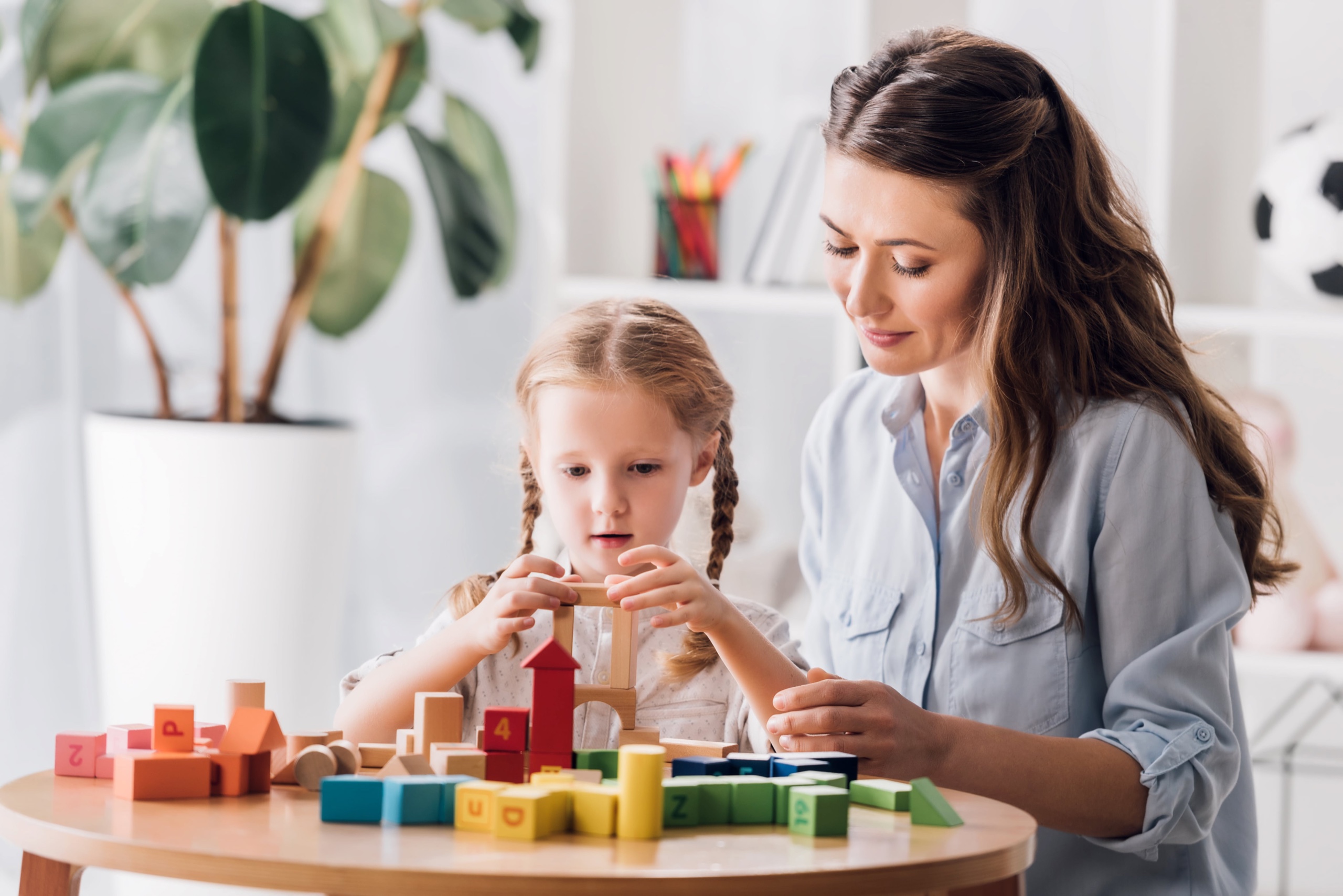 Therapist and child playing with blocks